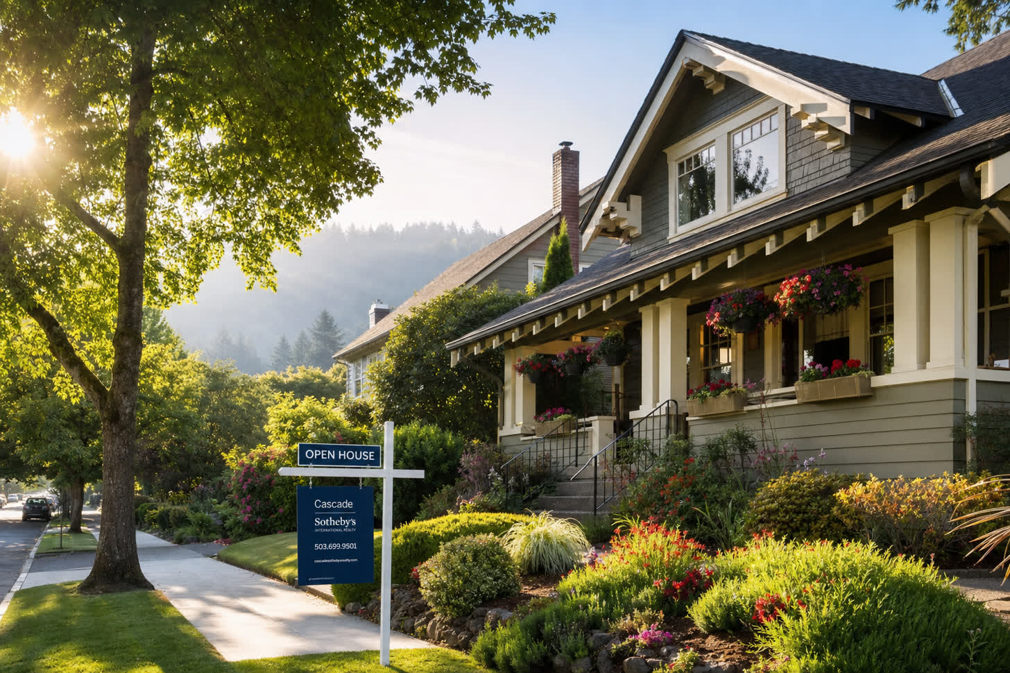 A West Linn craftsman home with an Open House sign on a quiet residential street with hanging flower baskets and morning sunlight